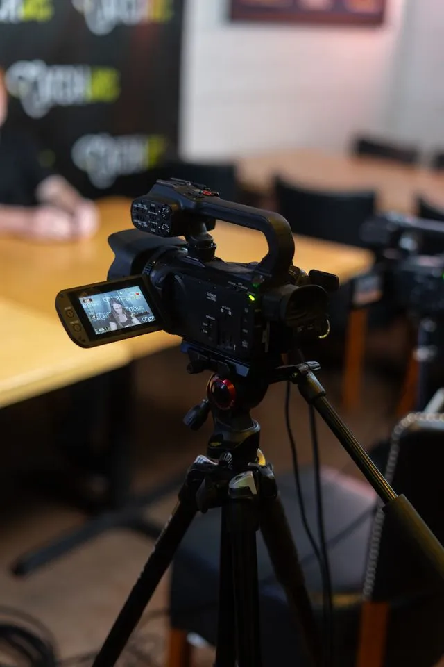 Camera set up to film a live shopping host at a table, DuneVision live shopping production setup