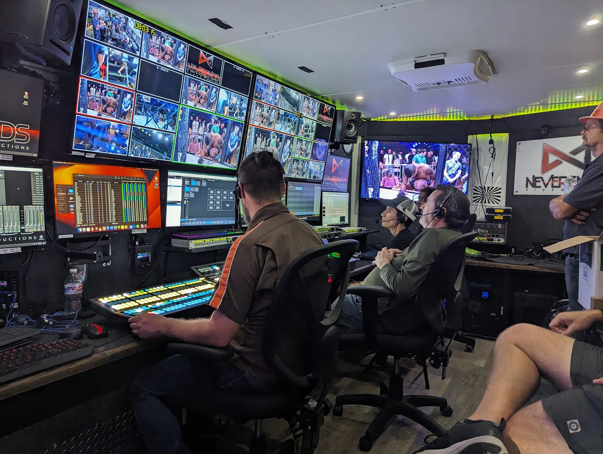 Full broadcast production truck with monitor wall and crew operating a large multi-camera live event