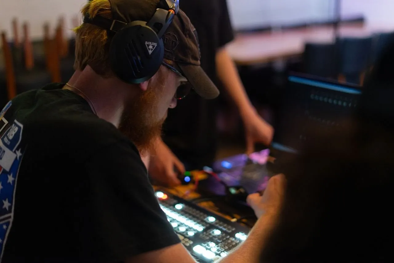 DuneVision crew operating audio mixing board during a live production