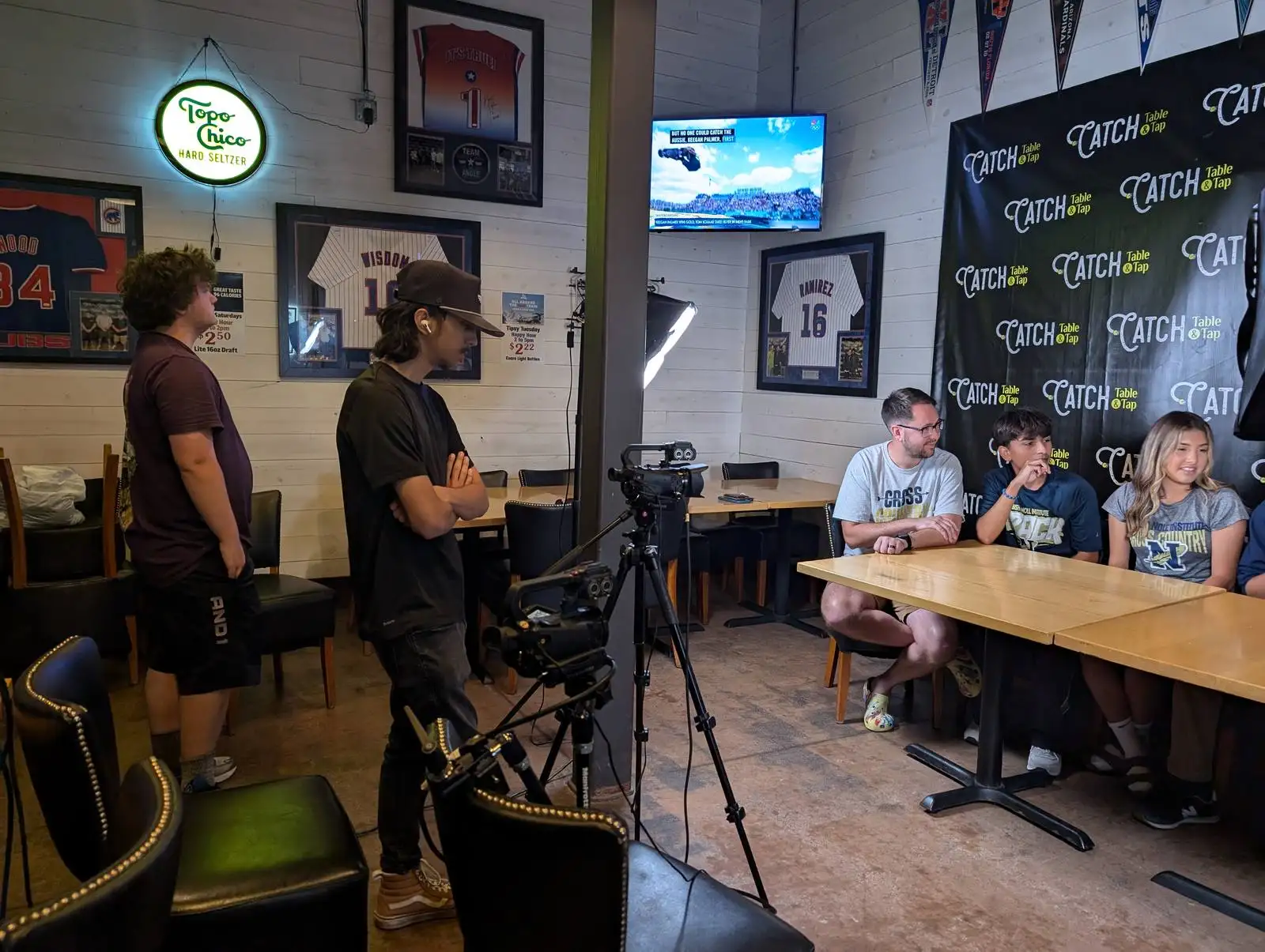 DuneVision crew with cameras and a laptop at an outdoor timing event