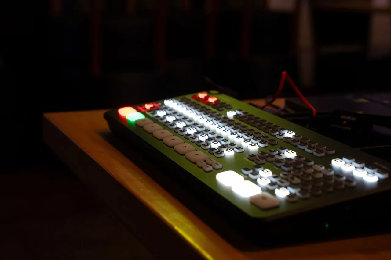 Live production switcher lit and active during a conference broadcast, DuneVision