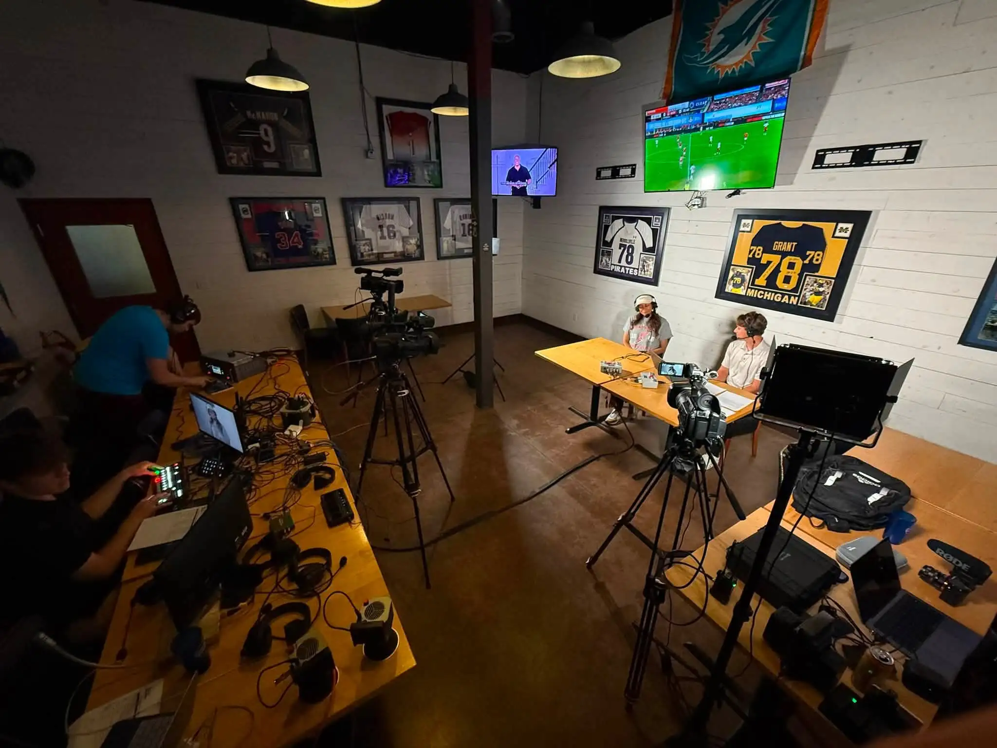 Two cameras covering a hosted conversation in a small studio