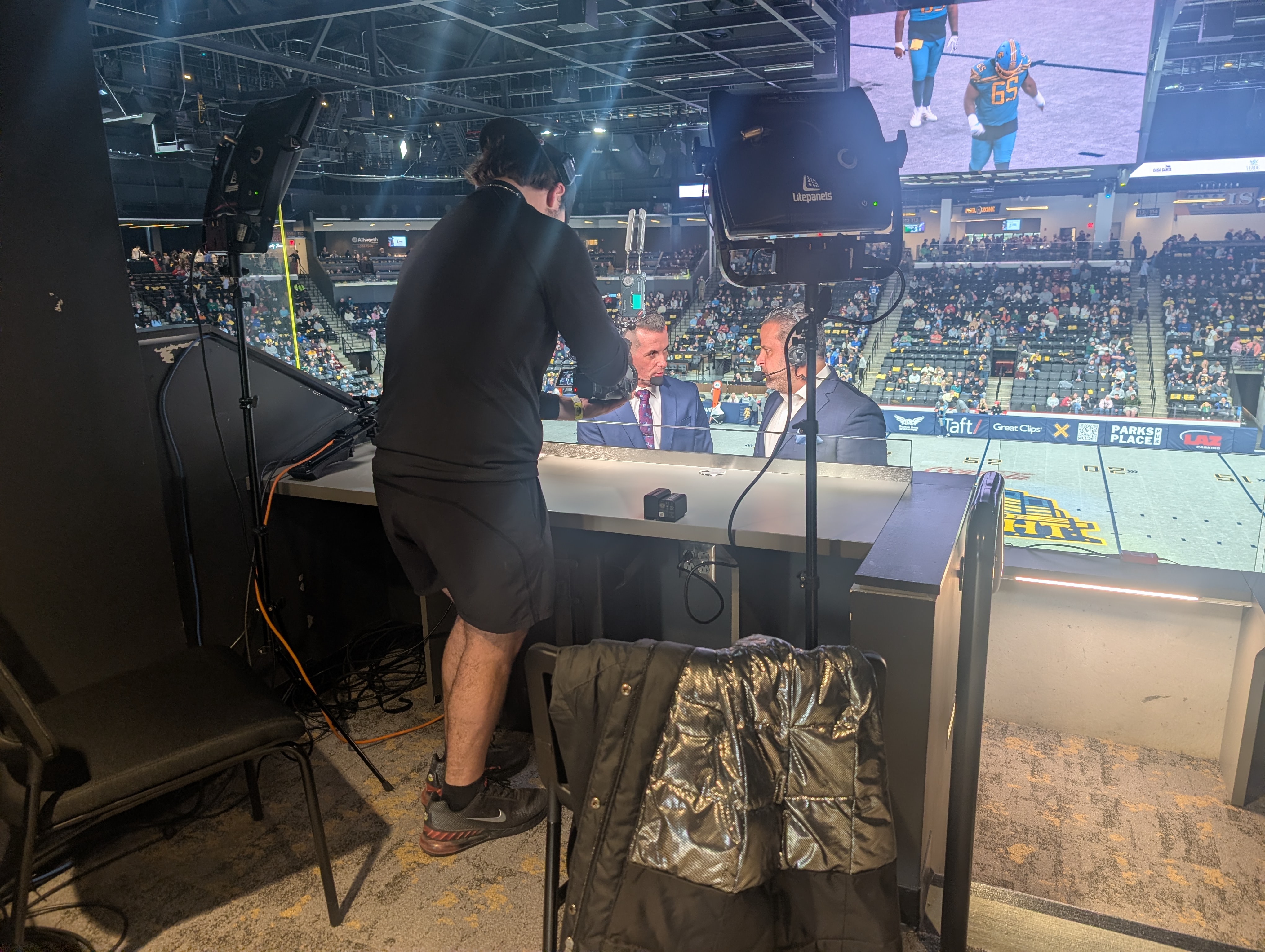 Broadcast announce booth with announcers on air and crew during a live IFL game at Fishers Event Center