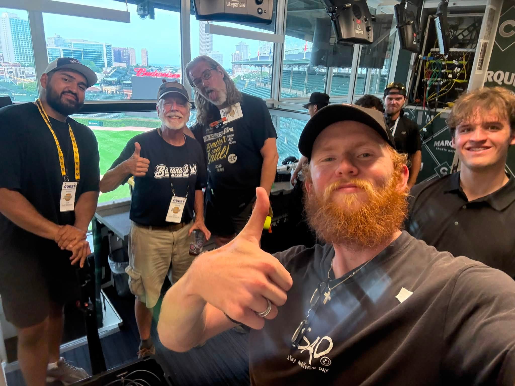 DuneVision crew members with the broadcast team in a press level booth overlooking the field at Wrigley Field